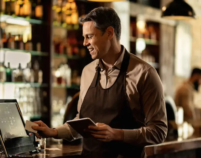 happy-barista-adding-order-cash-register-while-working-pub